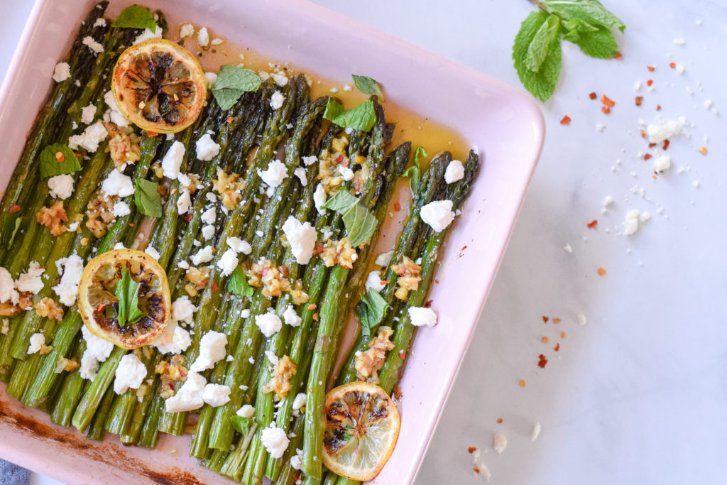 Roasted asparagus in a pink baking dish